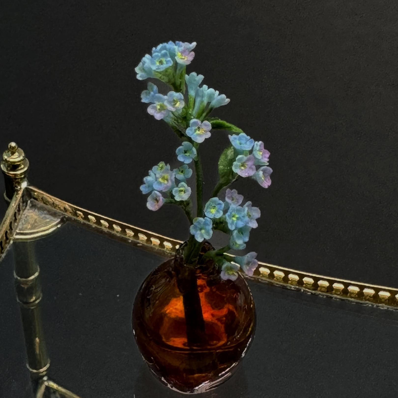 Forget-me-nots in the amber vase.